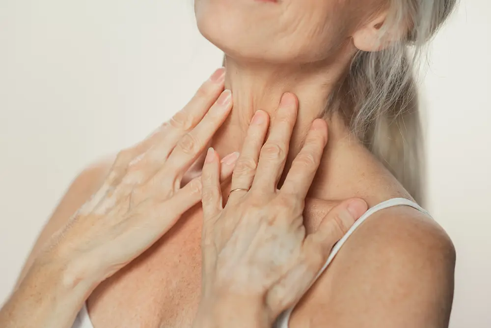 senior woman touching her neck