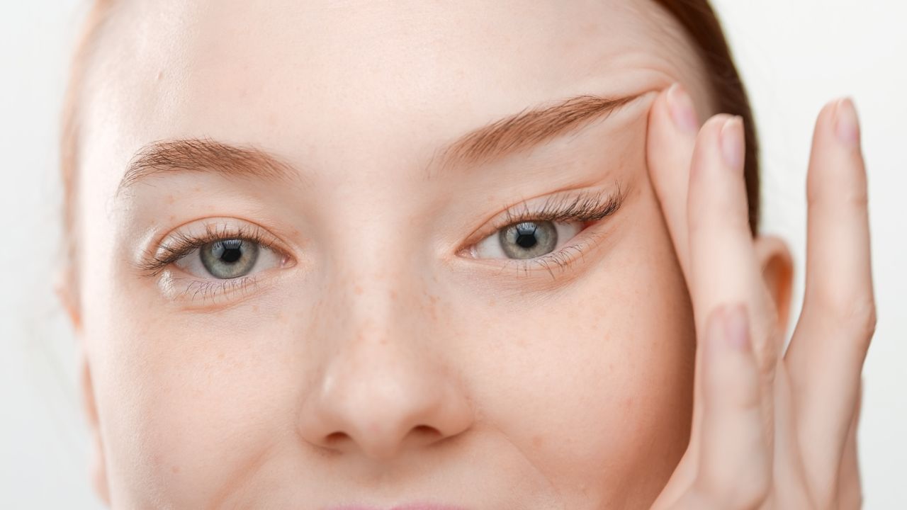 female skin care model lifts her eyes